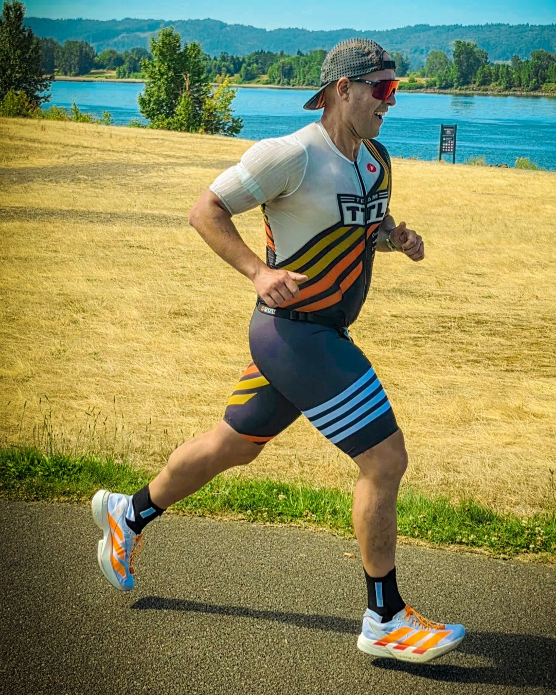 Zack Godwin running in Team TTL kit during a triathlon